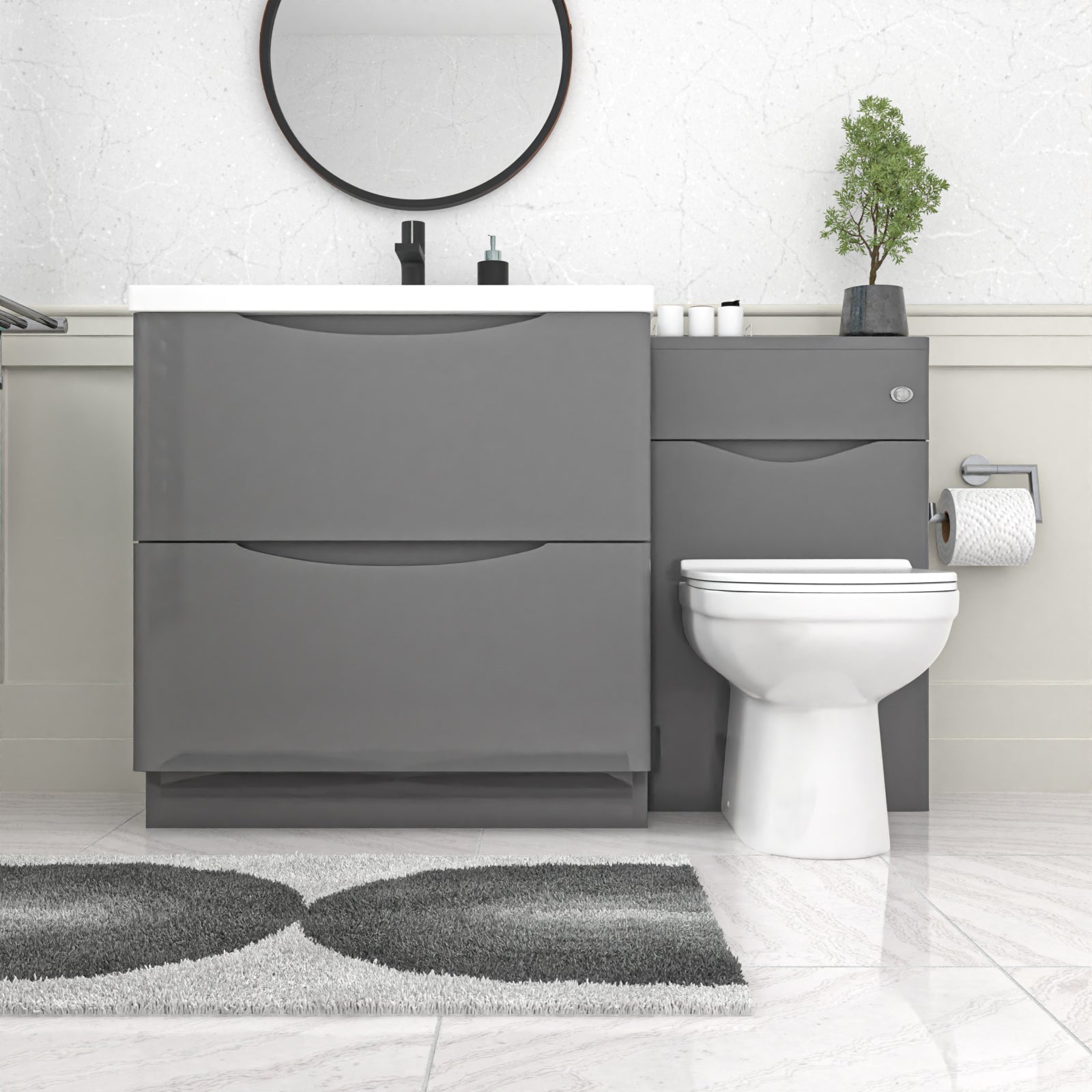 Bathroom setup with gray vanity unit, white toilet, and round mirror.