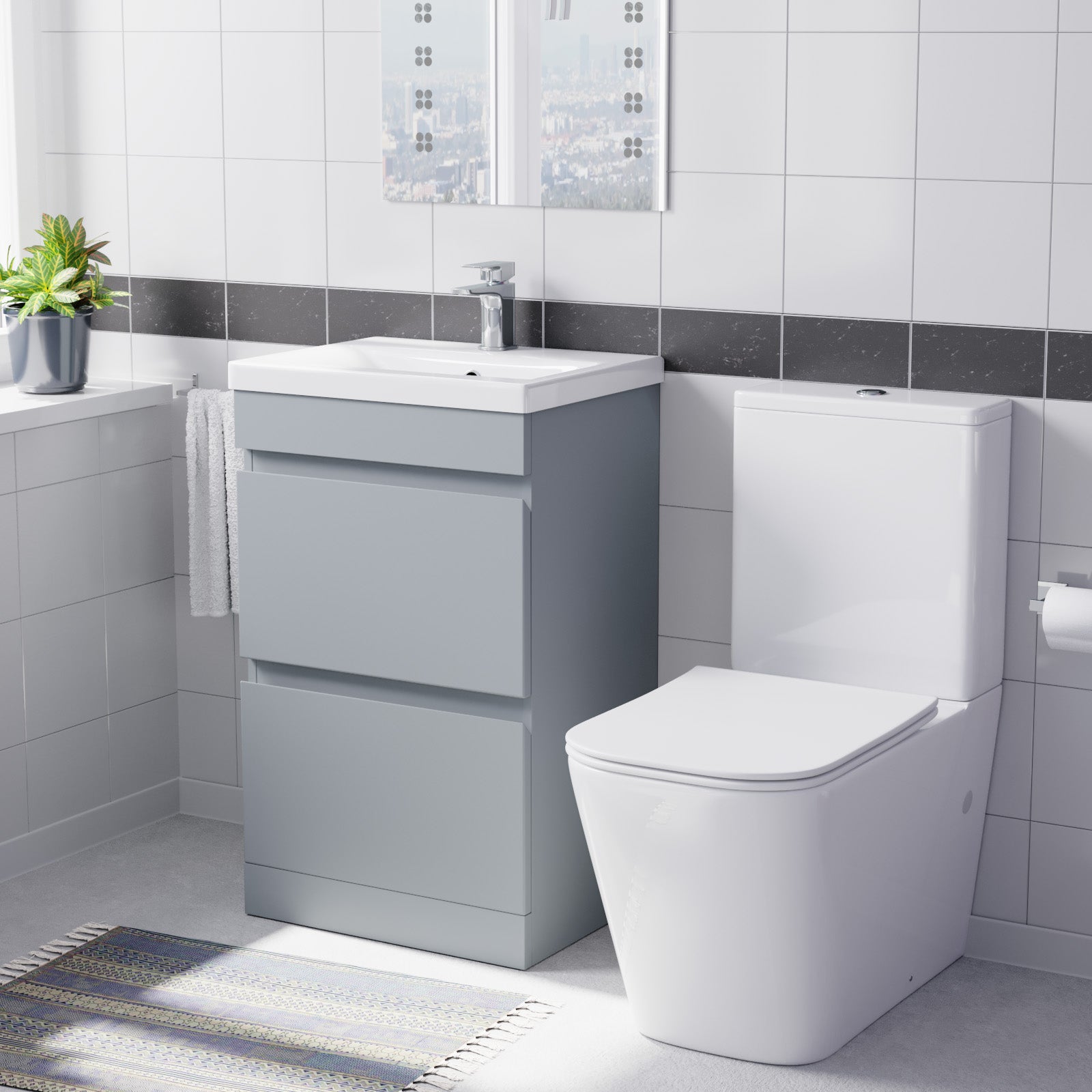 Bathroom setup with gray vanity unit, white sink, and toilet.