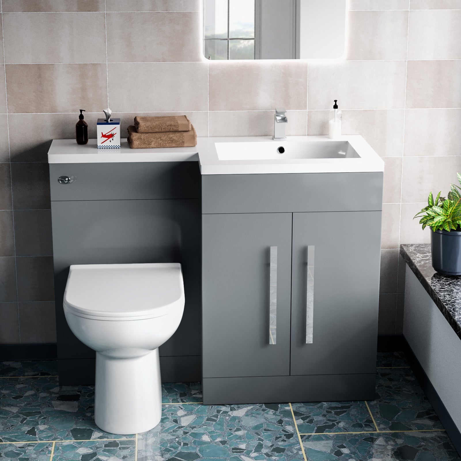 Bathroom setup with gray vanity unit, white toilet, and sink.