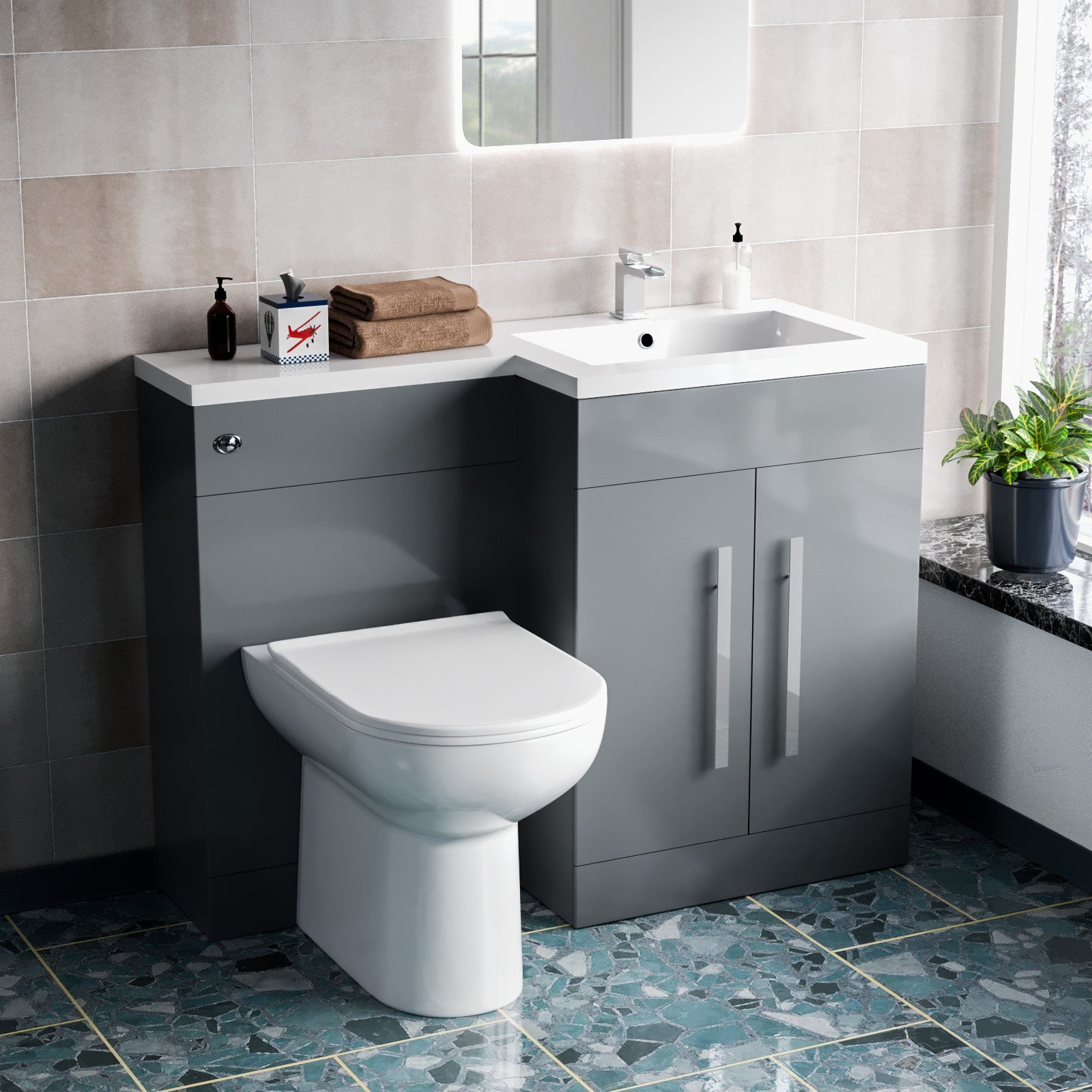 Bathroom setup with gray vanity unit, white toilet, and sink.