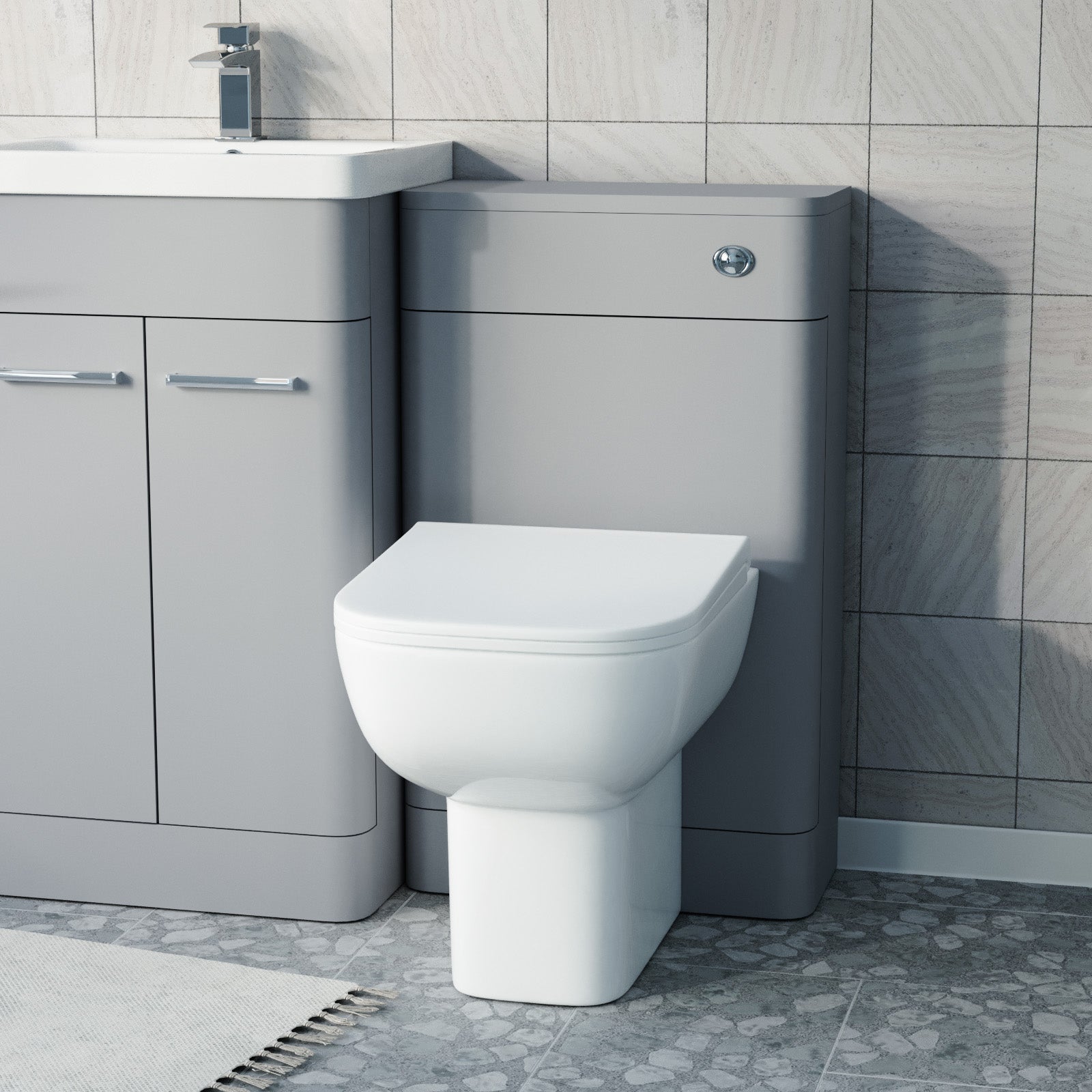 Gray toilet and sink unit in a bathroom setting 