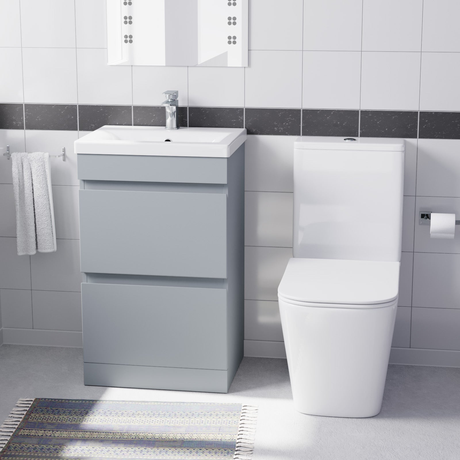 Bathroom setup with a gray vanity unit, white sink, and toilet 