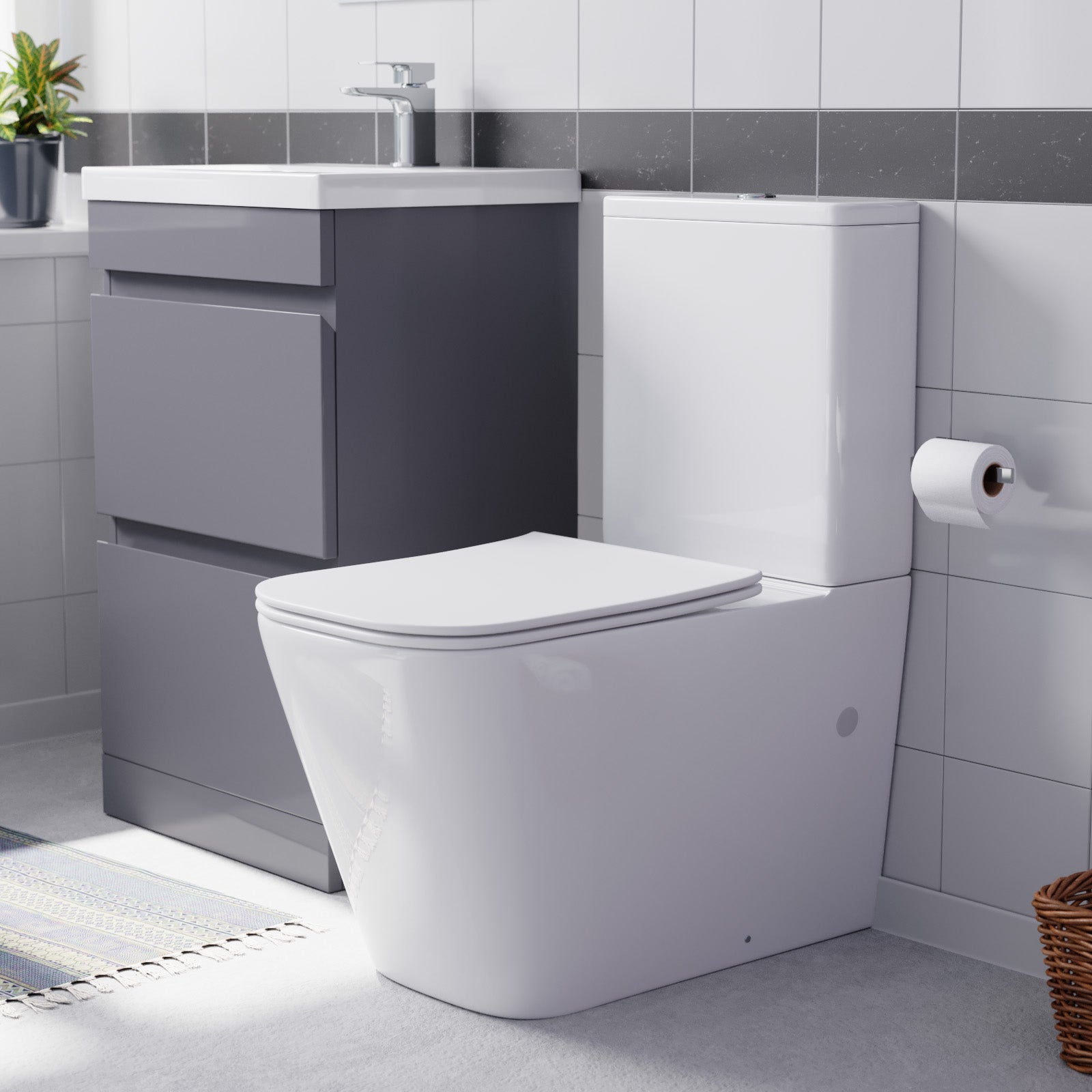 Modern bathroom setup with a toilet, sink, and storage unit.