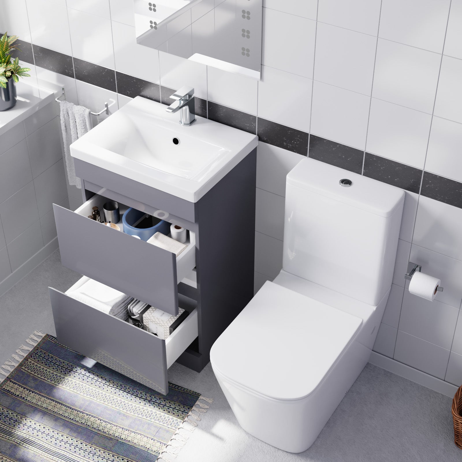 Bathroom setup with a toilet and vanity unit featuring open drawers.