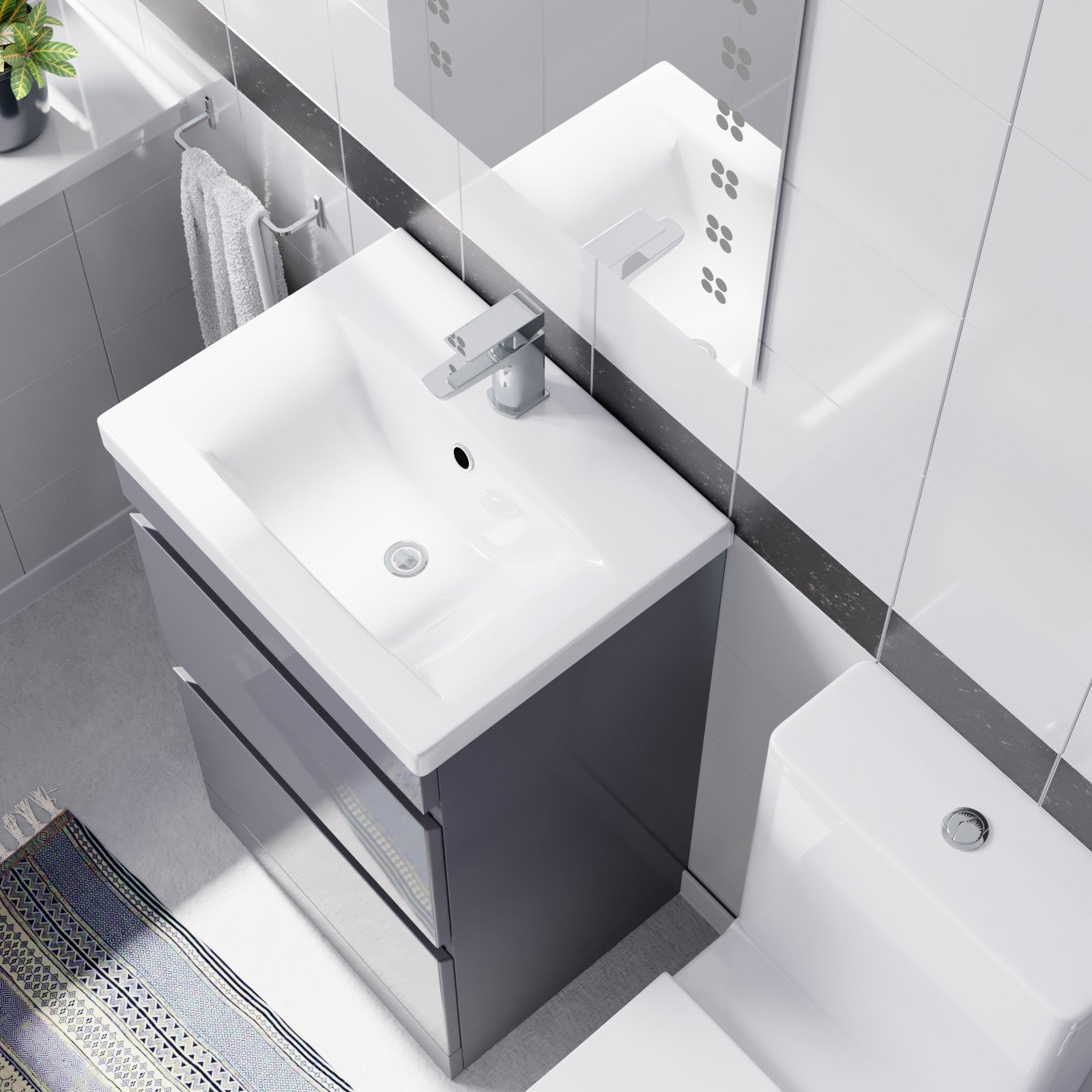 Bathroom vanity with white sink and gray cabinet in a modern bathroom setting.